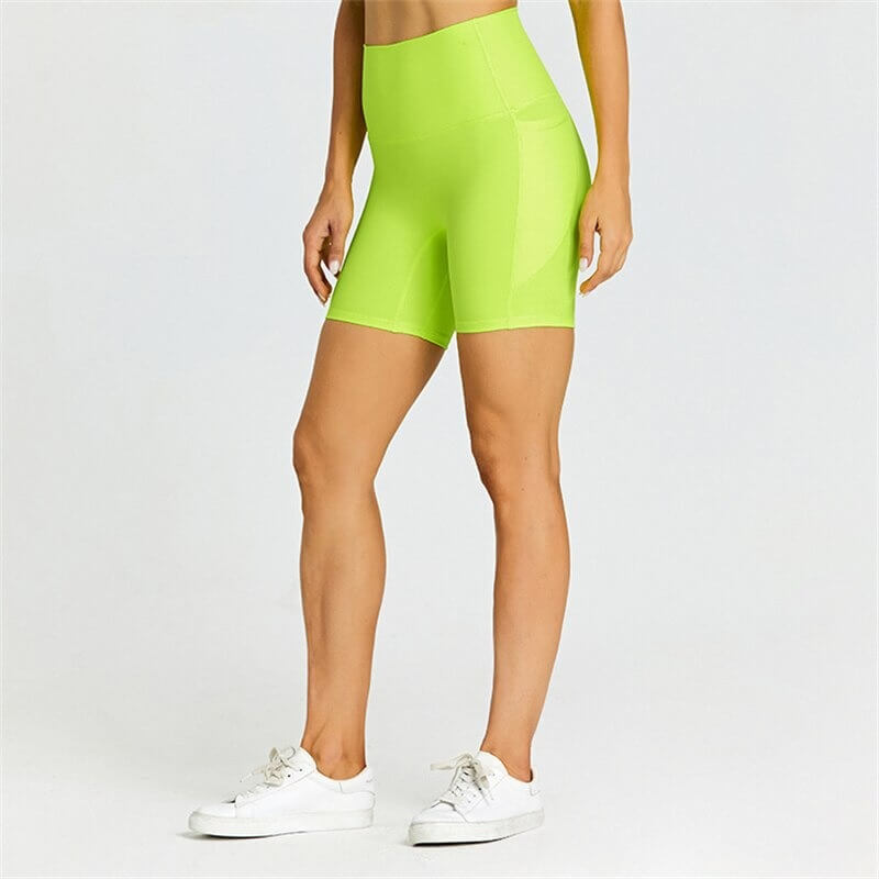 Lime green women's short tight solid color shorts with pockets, perfect for workouts, made from flexible nylon-spandex blend.