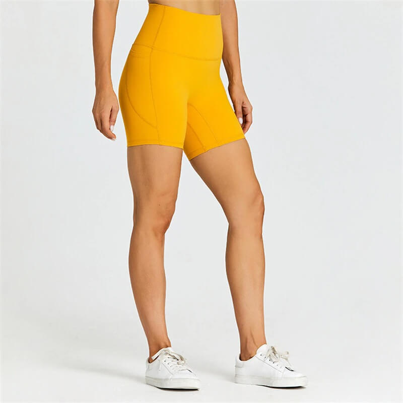 Women's solid color shorts with pockets, perfect for workouts. Lightweight nylon-spandex blend for comfort and mobility.