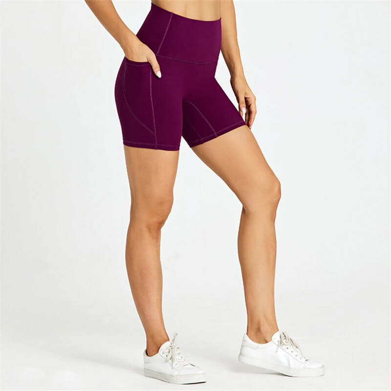 Women's short tight solid color shorts with pockets, perfect for workouts. Flexible, breathable nylon-spandex blend, comfortable fit.
