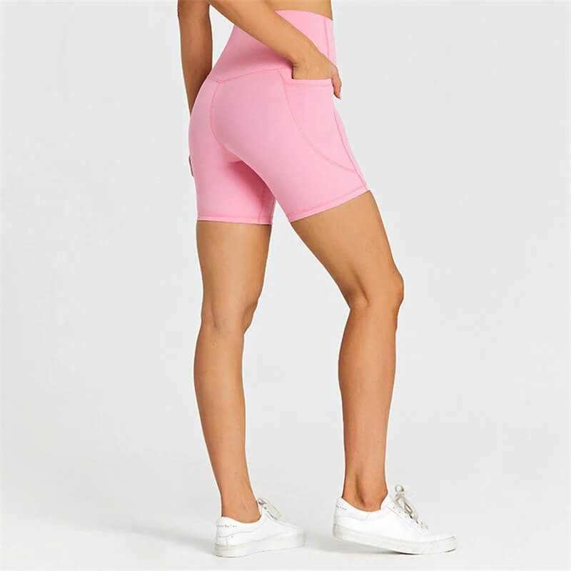 Women's short tight pink shorts with pockets, ideal for workouts, made of nylon and spandex for flexibility and breathability. SF0407