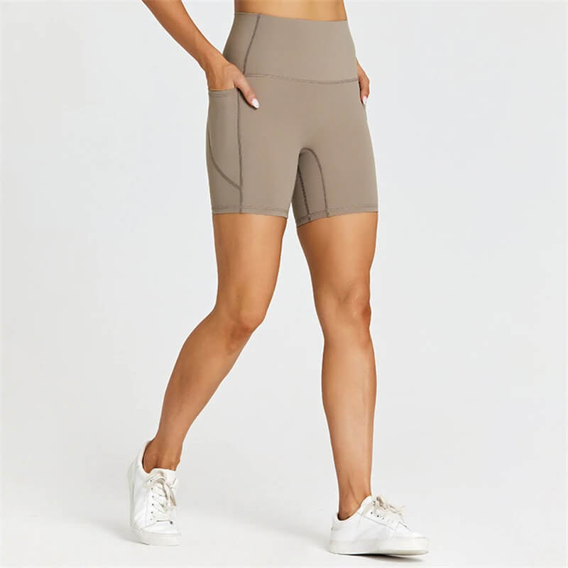 Women's short tight solid color shorts with pockets, perfect for workouts. Made from breathable nylon-spandex blend for comfort and mobility.