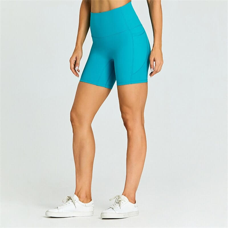 Women's short tight solid color shorts SF0407 with pockets, perfect for workouts, made from flexible nylon-spandex blend.