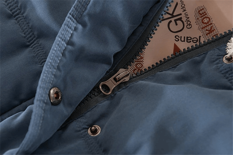 Close-up of blue sleeveless cotton jacket with zipper closure and buttons, showcasing elegant casual design and hooded vest style.