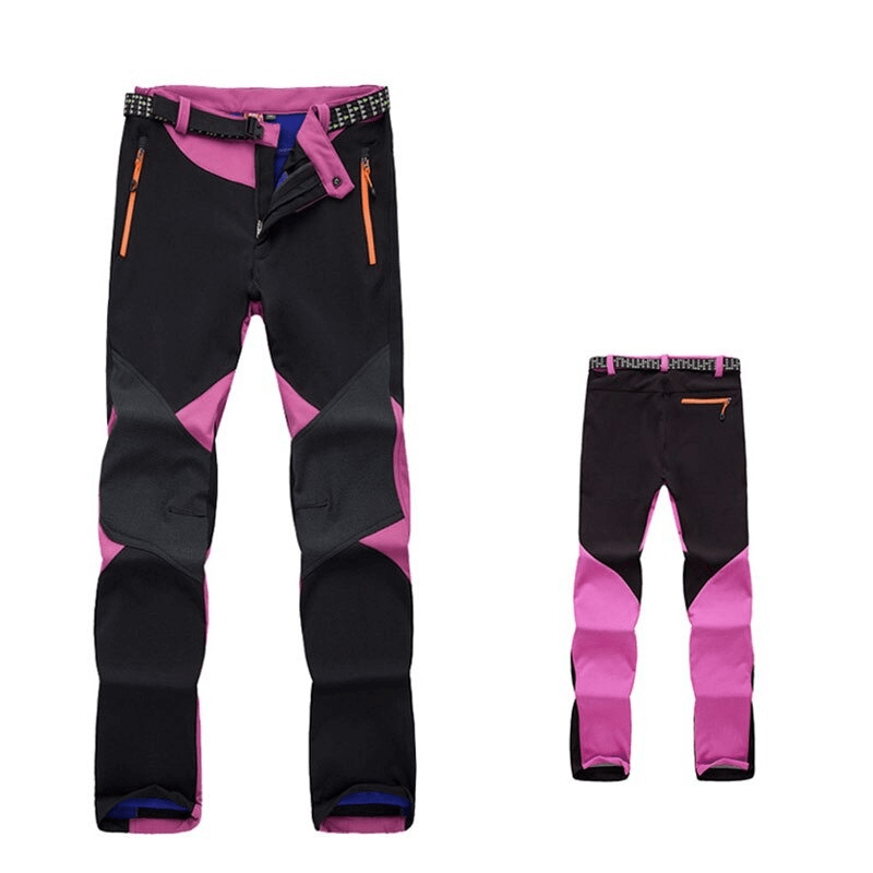 Stylish black and pink women's softshell ski pants with thermal technology and zipper closure, perfect for outdoor adventures.