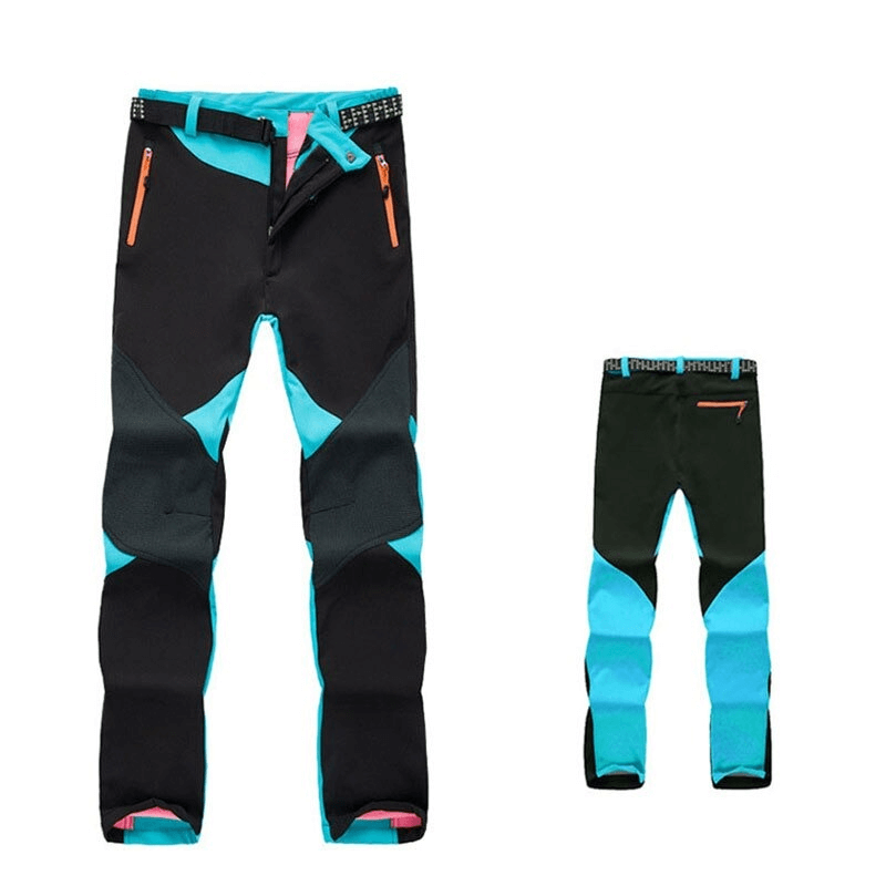 Women's softshell skiing pants, turquoise and black, with zipper fly and thermal technology for outdoor trekking and skiing. SF0716 model.