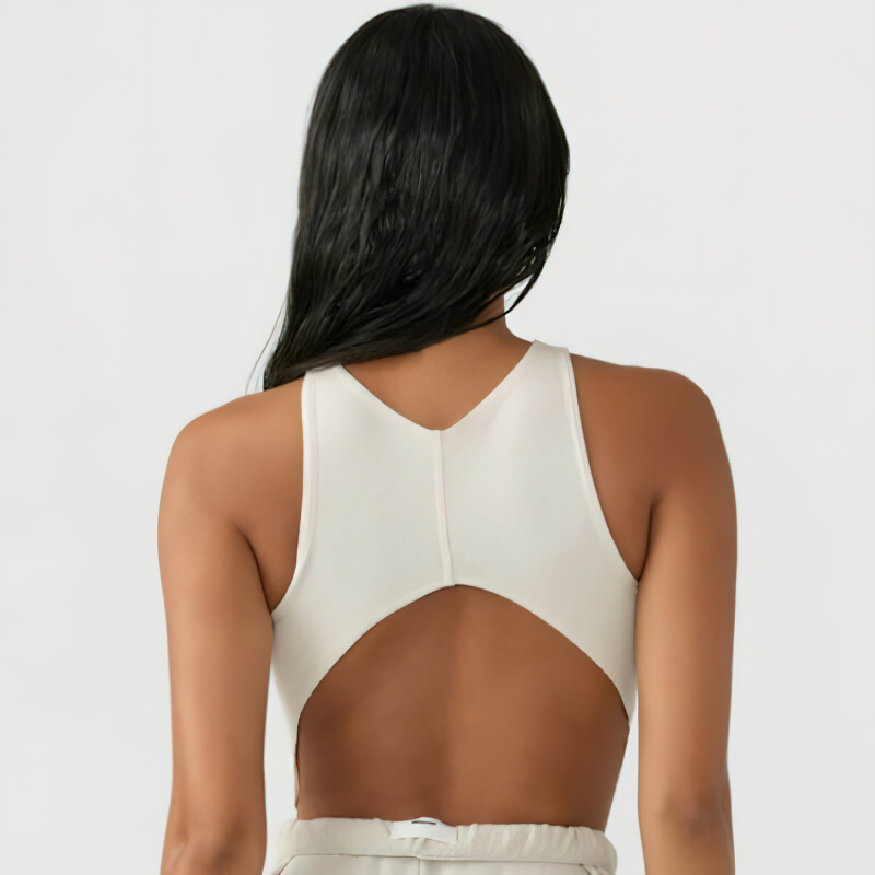 Woman wearing backless sleeveless gym crop top, SF1005, showing back design. Ideal for workouts. Nylon and spandex blend.