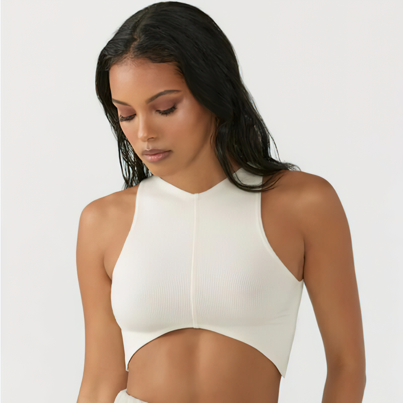 Model wearing women's solid sleeveless crop top with chest pad for gym, featuring a stylish backless design, in off-white color.