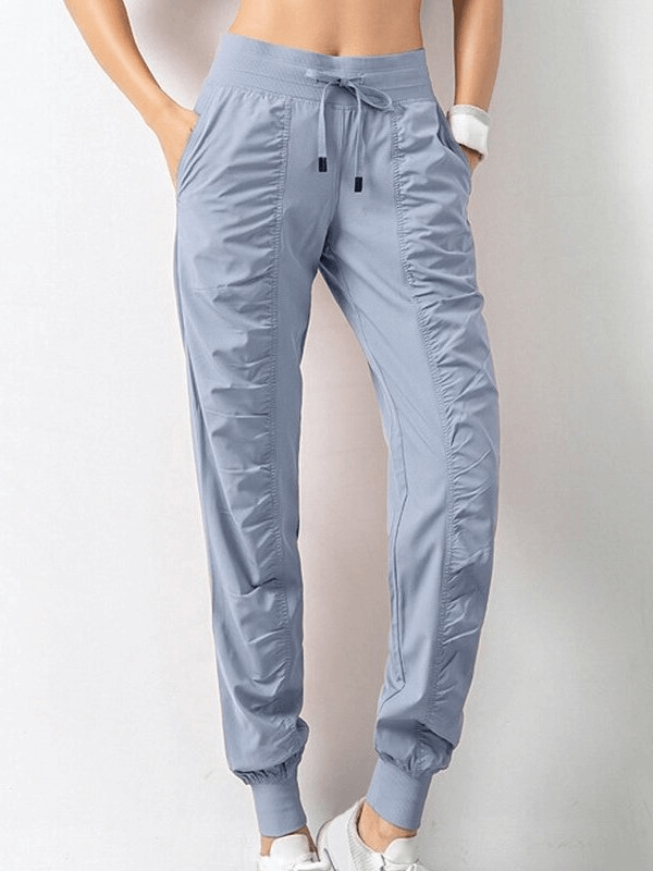 Women's Sports Joggers SF0177 with Side Pockets and Cuffed Hems in a loose fit, featuring a drawstring waist in light blue.