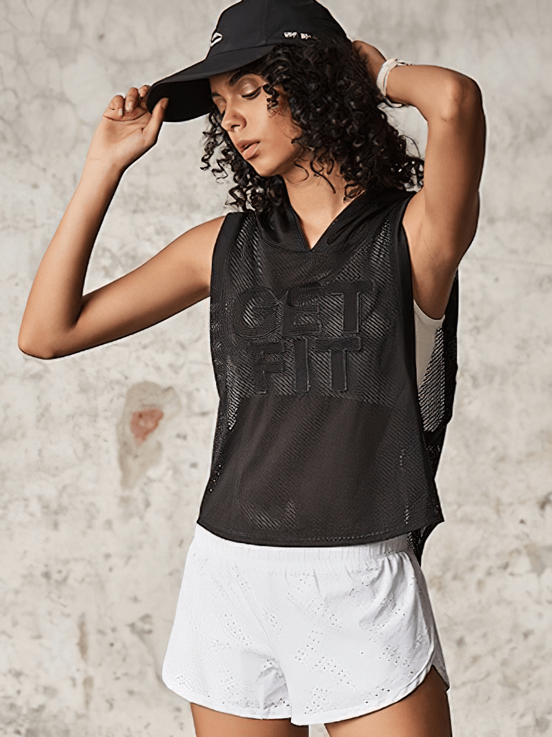 Woman wearing black hooded breathable mesh tank top and white shorts, perfect for activewear like yoga, running, and training.
