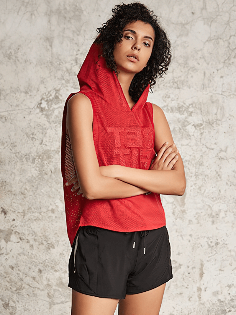 Woman wearing red breathable mesh hooded tank top, ideal for workouts like yoga and running.
