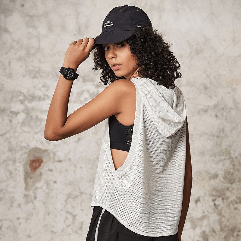 Woman in a loose white mesh hooded tank top, perfect for workouts, yoga, and running, showcasing its breathable and quick-dry features.