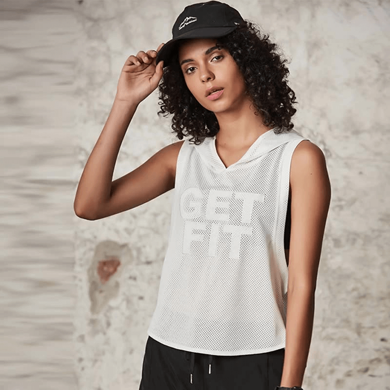 Model wearing a white mesh breathable hooded tank top with 'Get Fit' text, styled with a black cap, perfect for workouts and fitness.