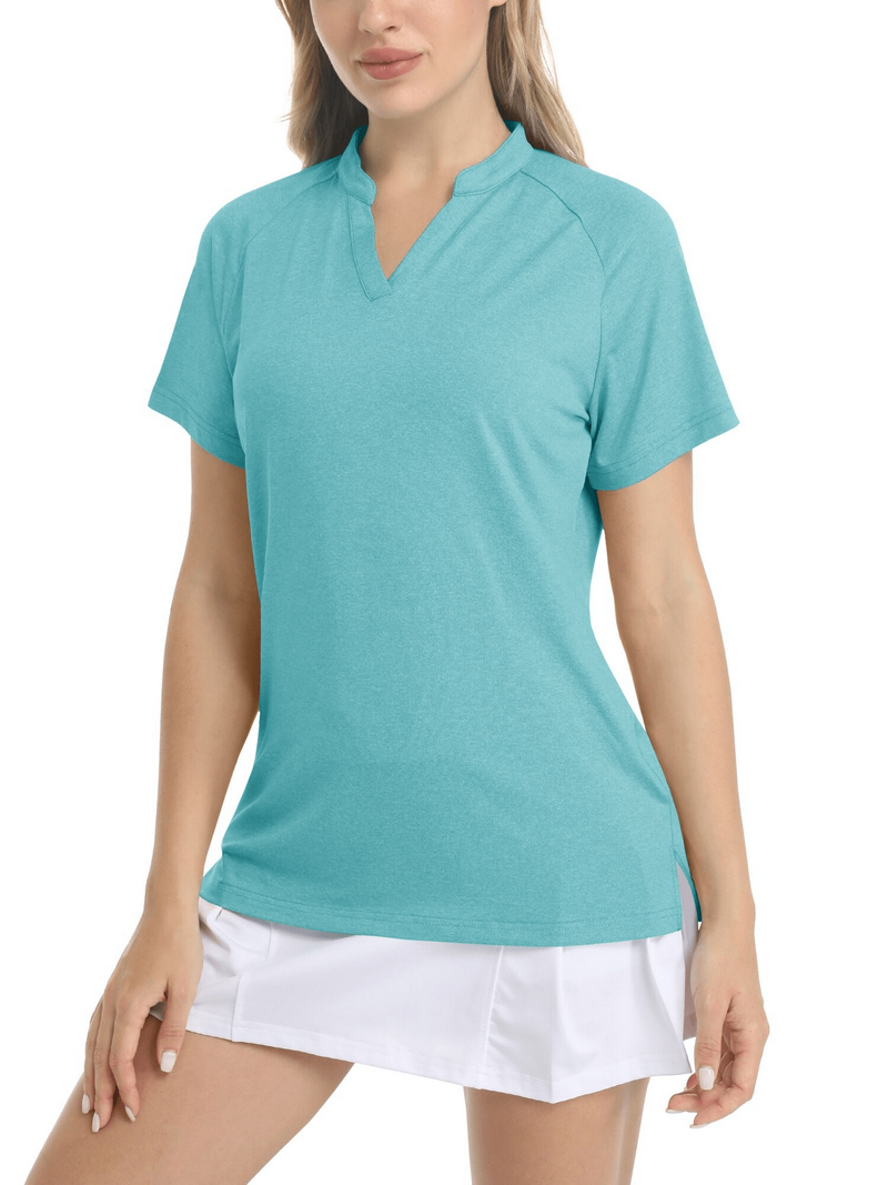 Woman wearing teal V-neck short sleeve sports t-shirt with white skirt, showing a casual sporty outfit style.