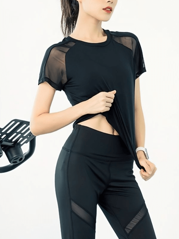 Woman wearing a black breathable quick-dry sports t-shirt with mesh back, ideal for yoga and training, showcasing activewear style.