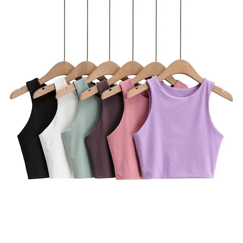 Colorful women's seamless cropped sports tops on hangers, perfect for breathable workout comfort and mobility.
