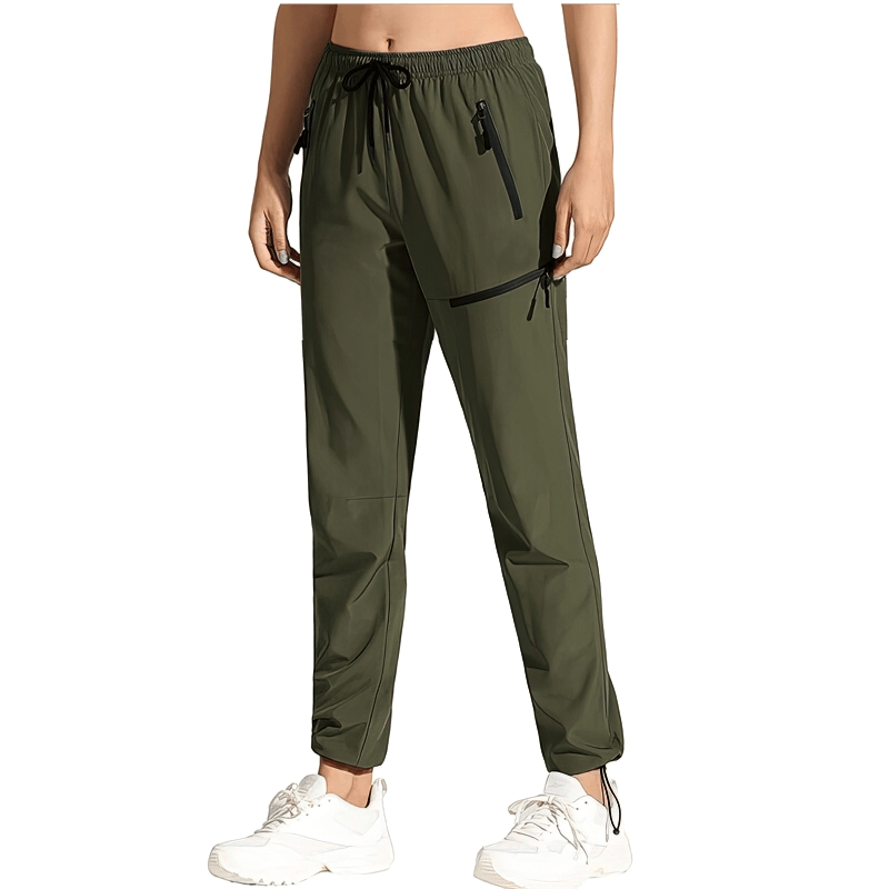 Woman wearing green waterproof quick-drying hiking pants with pockets and elastic waist, ideal for outdoor activities.
