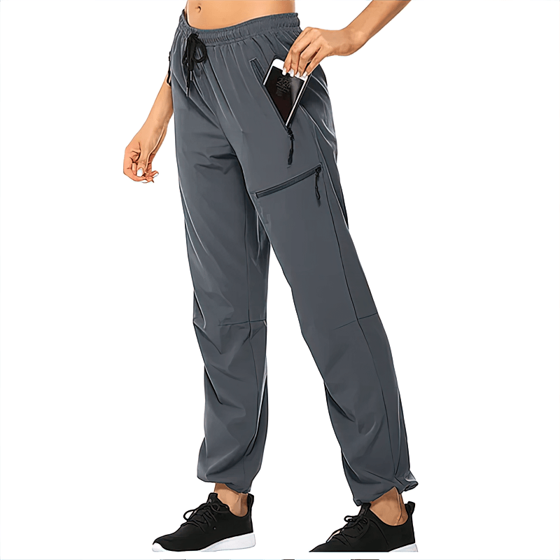 Women's waterproof quick-drying hiking pants with pockets, gray, featuring elastic waist and 4-way stretch for outdoor sports.