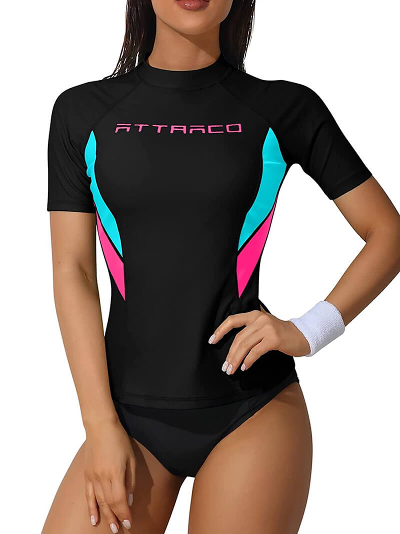 Women's black crew neck rashguard swimwear with short sleeves, featuring colorful accents, ideal for UV protection in surfing.