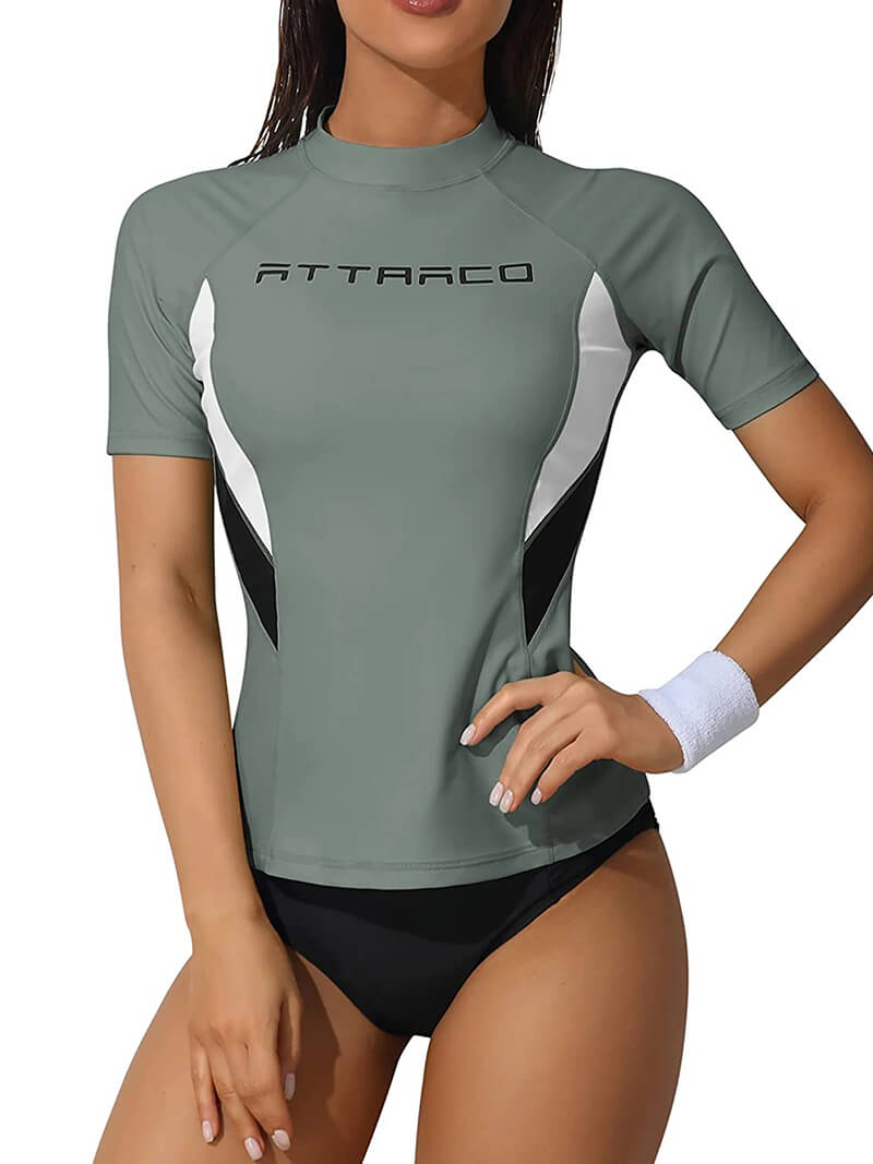 Women's gray short sleeve surfing rashguard swimwear with crew neck, offers UV protection, made of nylon and spandex for a snug fit.