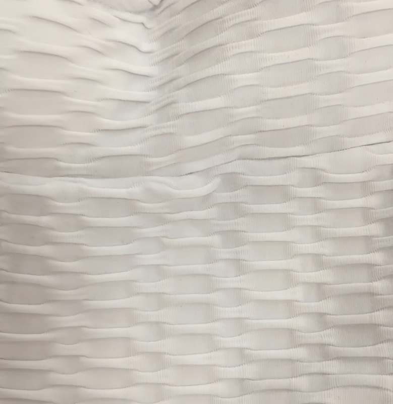 Close-up of textured fabric detail from Women's Textured Open-Back Yoga Jumpsuit in white.