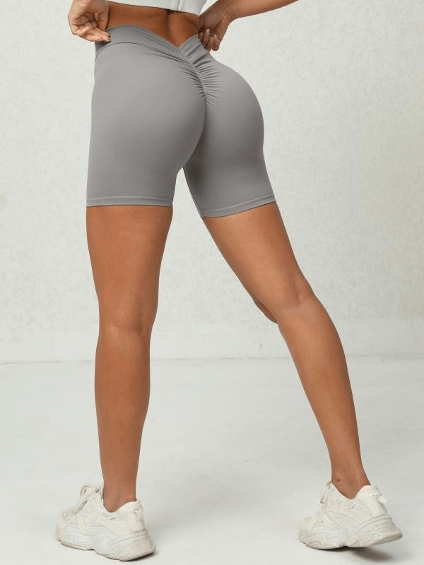 Back view of gray women's solid color sports shorts for training with elastic waist, perfect for yoga and gym workouts.