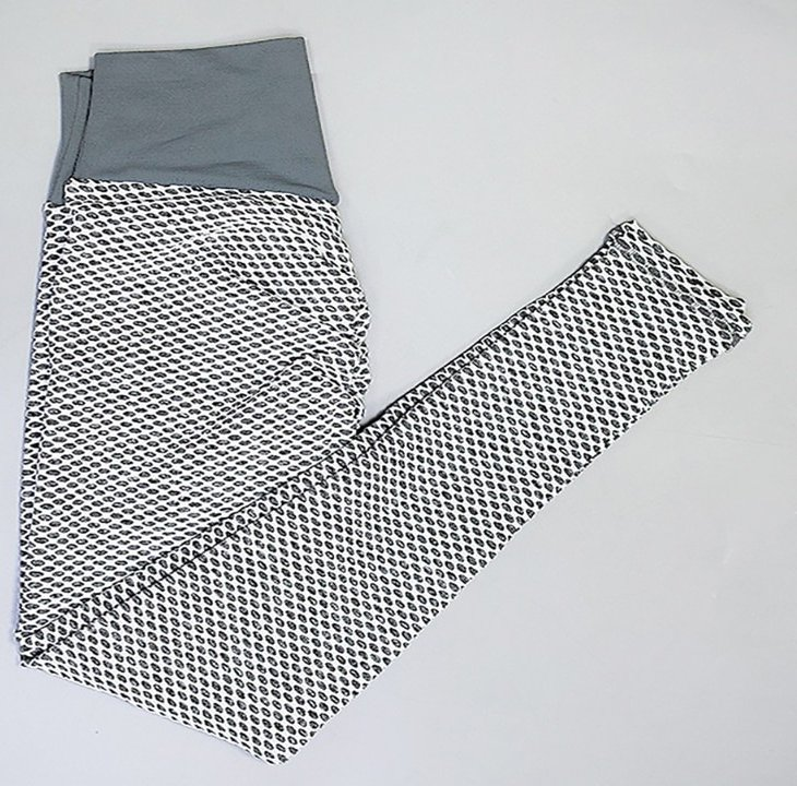 Black and white patterned high-waisted workout leggings with a grey waistband, made of polyester for a chic and flexible fit.