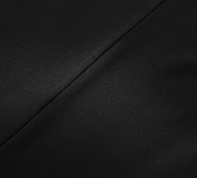 Close-up of black polyester fabric, showcasing sleek texture and seamless design of the Women's Tight Sexy Short Jumpsuit with Straps.