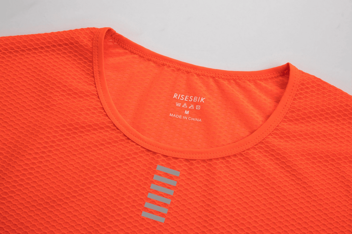 Women's ultralight long sleeves cycling base layer top in bright orange with breathable fabric and reflective stripes, model SF0222.