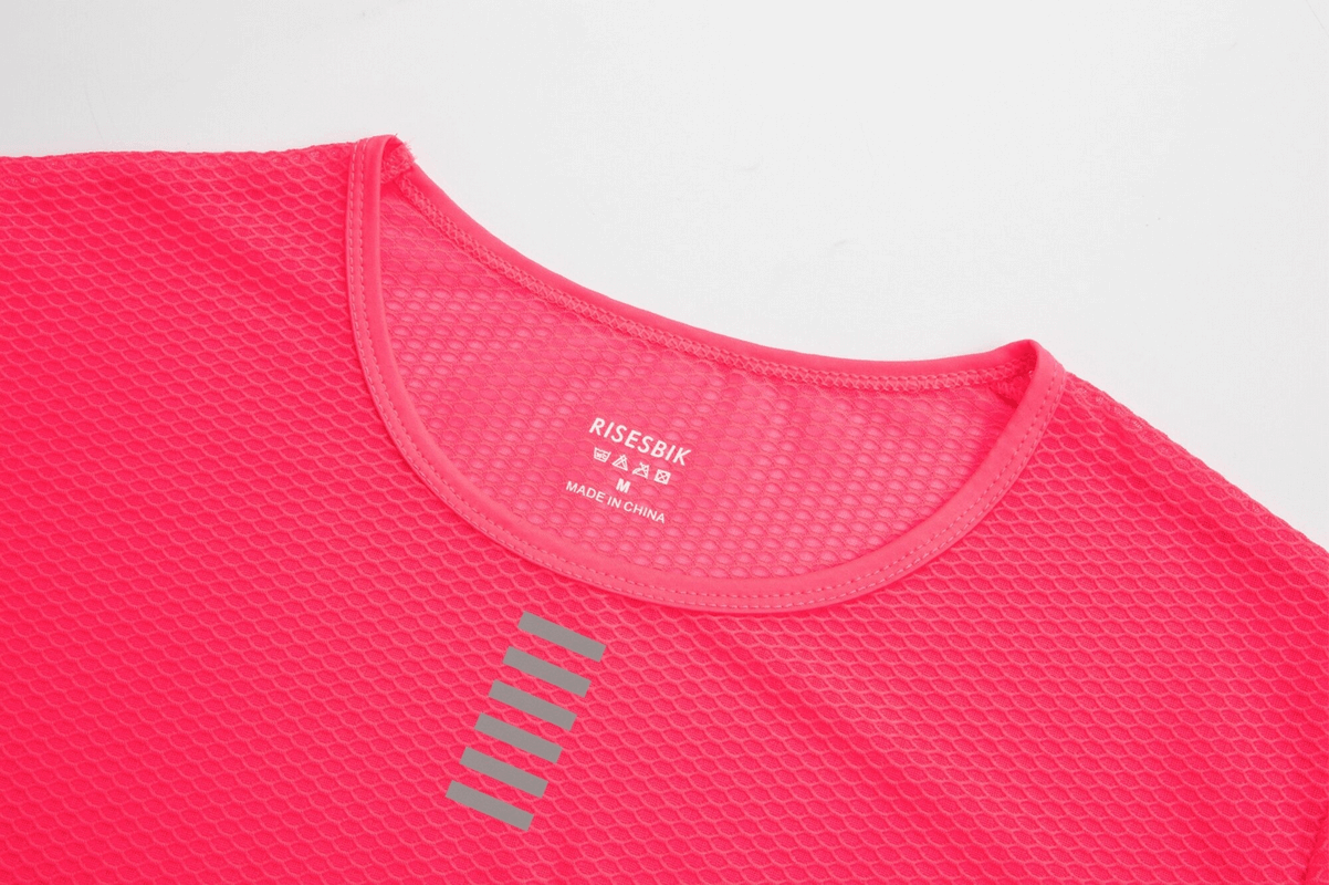 Close-up of pink women's ultralight long sleeves cycling base layer top with reflective details for high-performance cycling comfort.