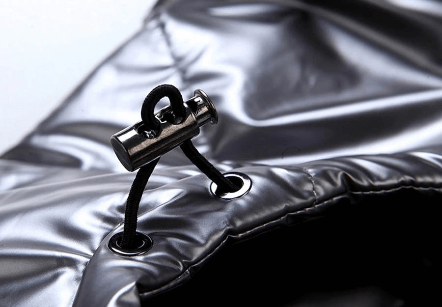 Close-up of shiny black drawstring with metallic toggle on a women's hooded vest.