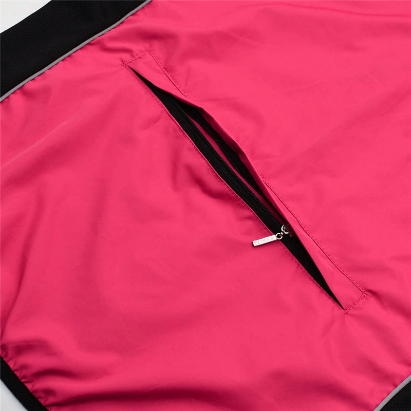 Close-up of women's waterproof cycling jacket with zippered back pocket in bright pink.