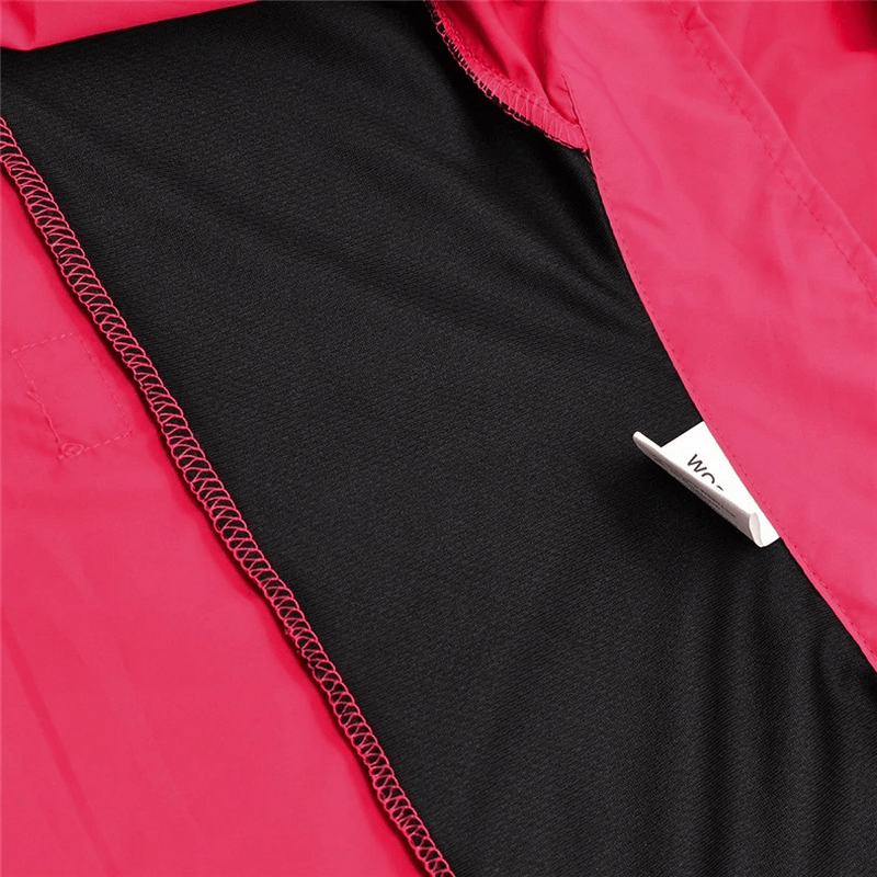 Close-up of pink waterproof cycling jacket seam, featuring a breathable black lining.