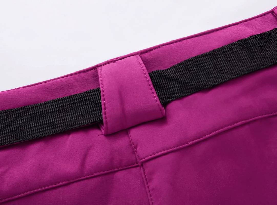 Close-up of Women's Waterproof Sports Pants waist detail, vibrant fabric with black belt loop. Ideal for hiking, offers comfort and protection.