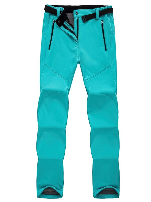 Women's turquoise waterproof sports pants with fleece lining, zipper pockets, and adjustable waistband, ideal for hiking.