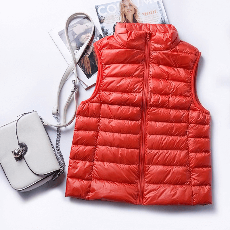 Red Women's Windproof Duck Down Vest with pockets next to a stylish white handbag, showcasing slim, lightweight design.