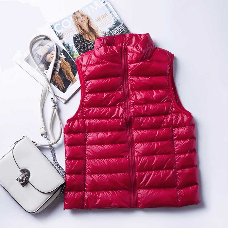 Women's red windproof duck down vest with waterproof zipper and pockets, perfect for style and comfort on the go.