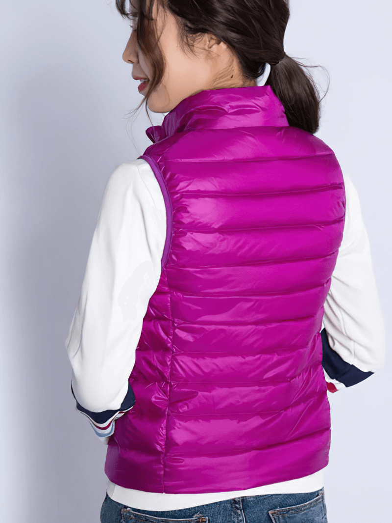 Woman wearing a vibrant purple windproof duck down vest with waterproof zipper; perfect for style, comfort, and insulation.