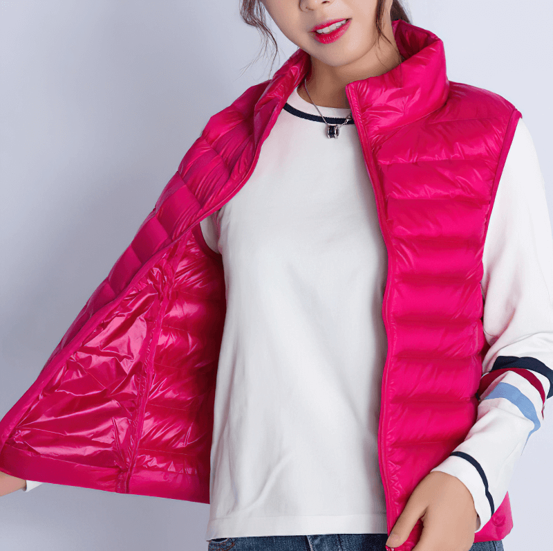 Woman wearing a pink windproof duck down vest with a zipper, showcasing its stylish and lightweight design.