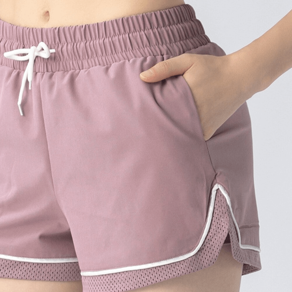 Women's workout shorts with adjustable drawstring, featuring breathable pink fabric, ideal for yoga and high-performance activities.