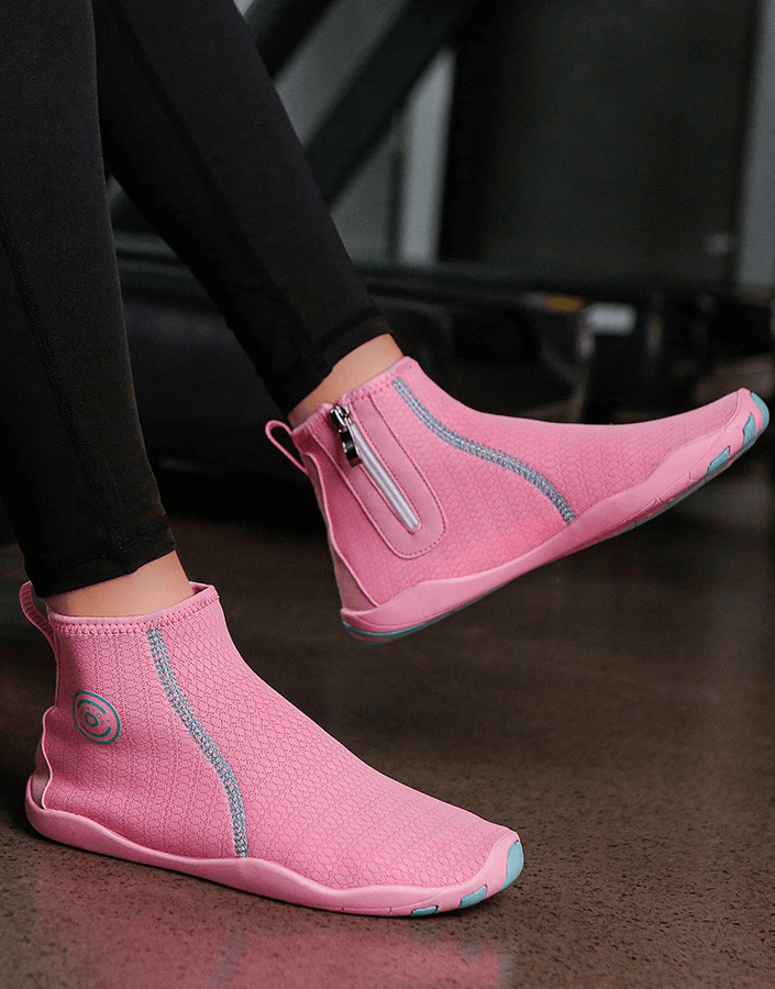 Person wearing pink breathable water shoes with zipper and non-slip soles, perfect for swimming and outdoor sports.