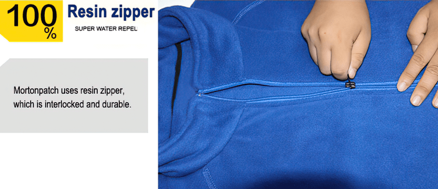 Person zipping up blue hiking jacket with durable resin zipper, showcasing windproof and thermal features for outdoor sportswear