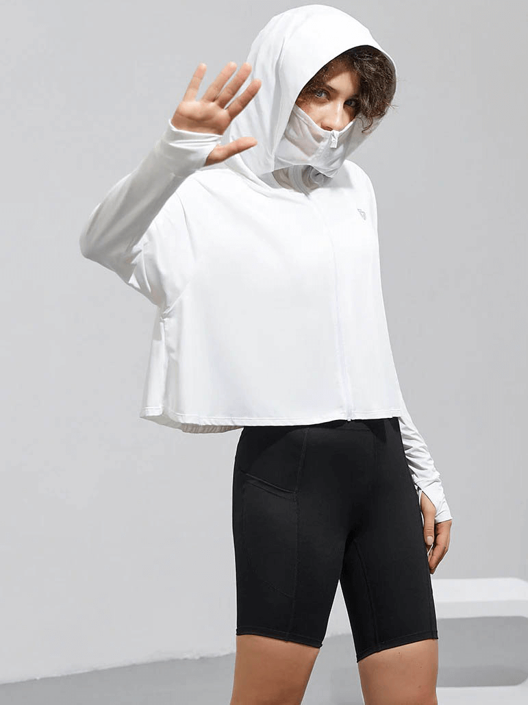 Woman wearing a white sun protection hoodie and black shorts, perfect for sports and active lifestyle. Features zipper and long sleeves.