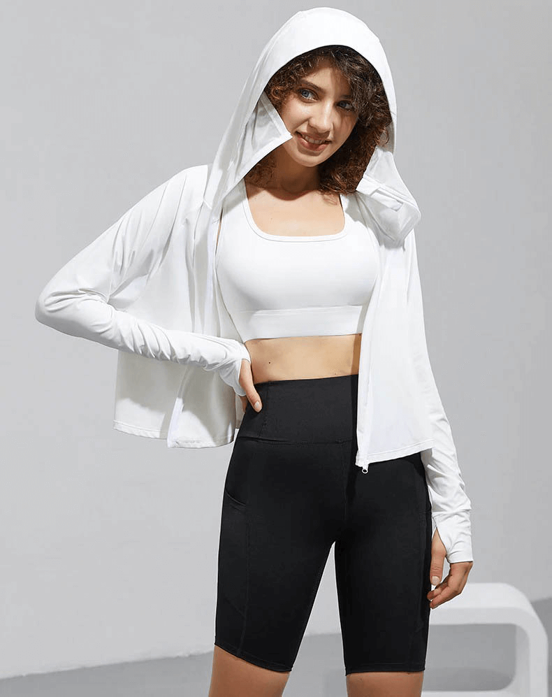 Woman wearing a white zipper long sleeve sun protection hoodie, ideal for yoga and running, showcasing flexible nylon-spandex fabric.
