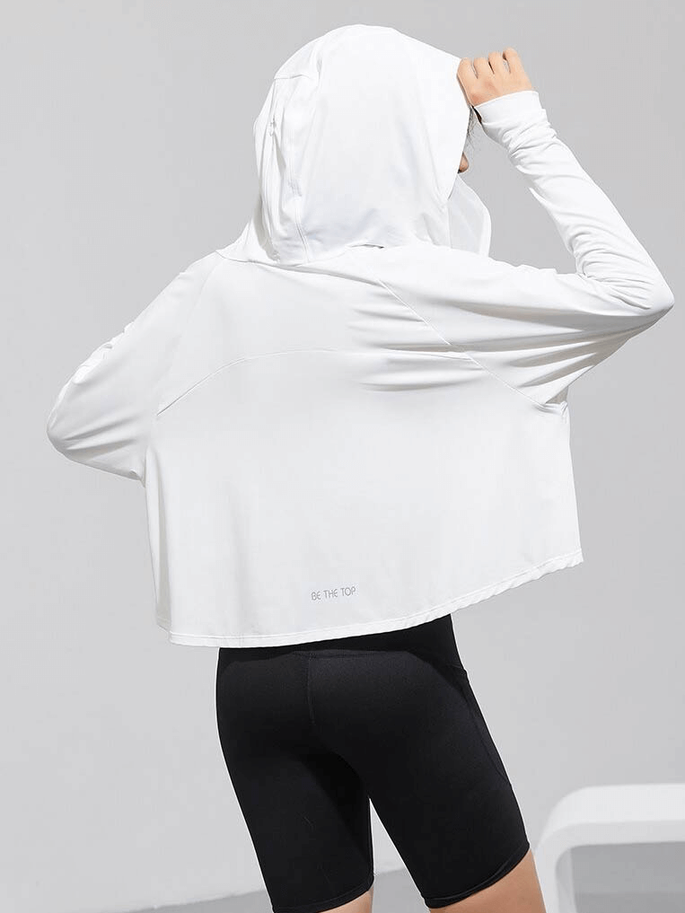 Woman wearing white sun protection hoodie with zipper and long sleeves, perfect for workout and active sports.